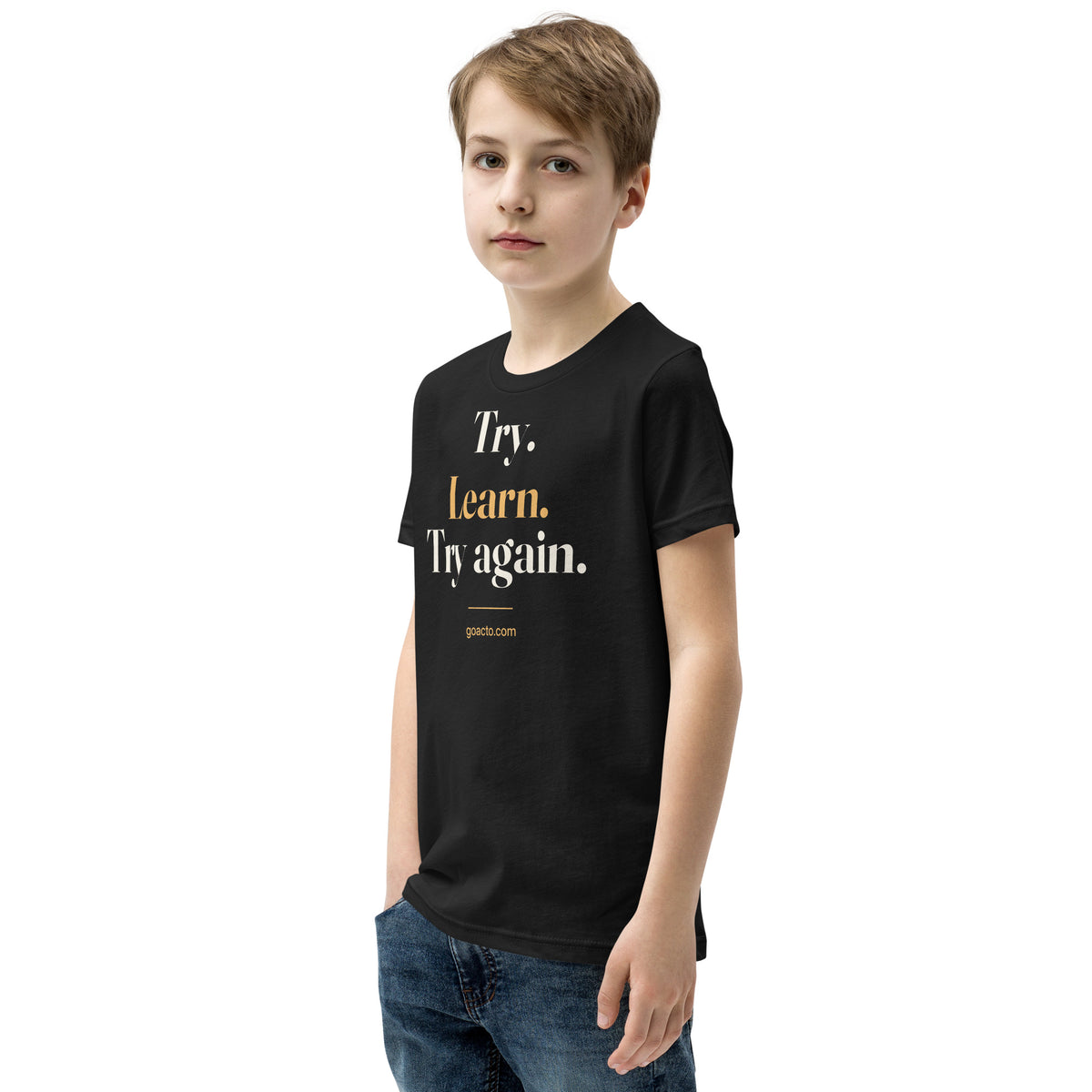 Try. Learn. Try Again. Youth Tee, black, worn by a young model turned slightly left, showing the stacked "Try. Learn. Try again." print