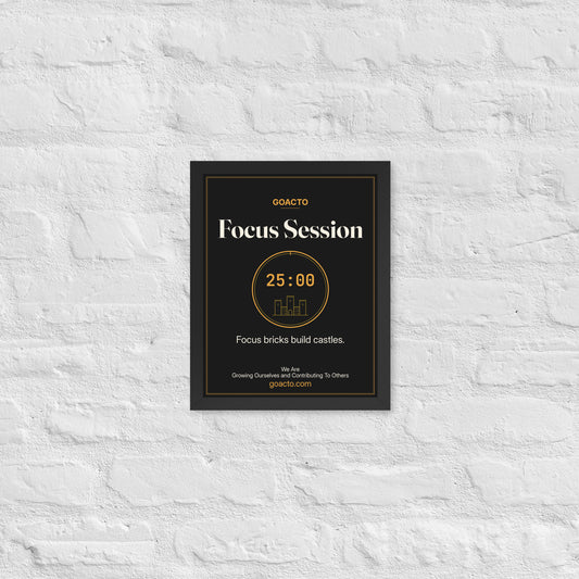 Focus Session Framed Print, Brick Rise design, 11x14 in a black frame on a white brick wall: thin amber ring around a 25:00 timer with a small line-drawn castle inside, on charcoal, the line 'Focus bricks build castles.' and 'We Are / Growing Ourselves and Contributing To Others' above goacto.com