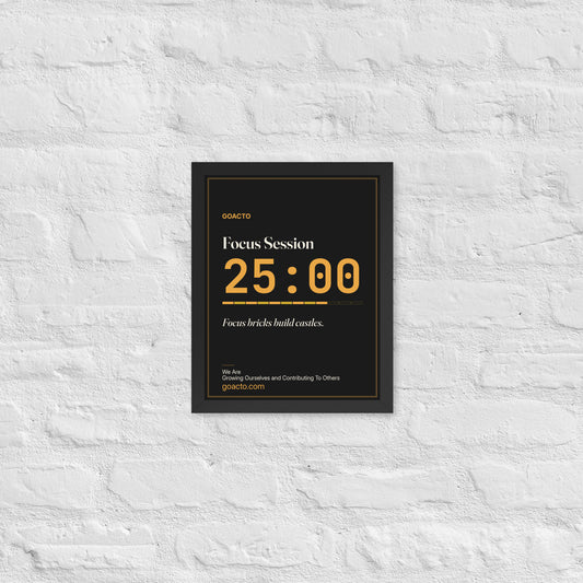 Focus Session Framed Print, Type design, 11x14 in a black frame on a white brick wall: oversized amber 25:00 above a segmented progress bar, on charcoal, the line 'Focus bricks build castles.' and 'We Are / Growing Ourselves and Contributing To Others' above goacto.com
