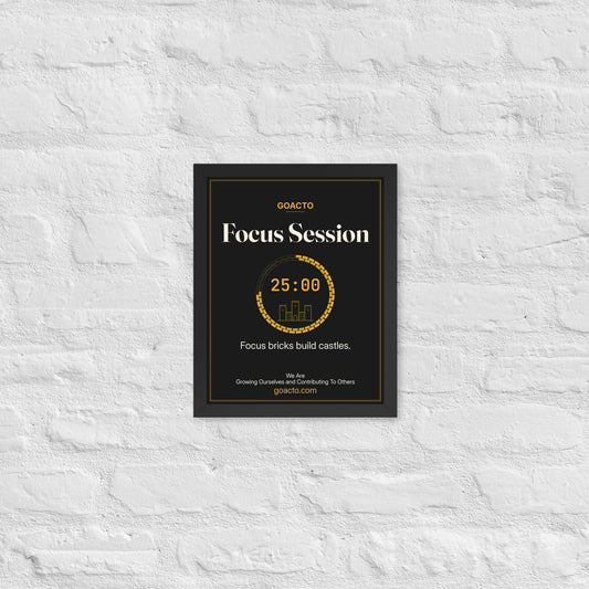 Focus Session Framed Print, Castle Ring design, 11x14 in a black frame on a white brick wall: ring of amber bricks around a 25:00 timer with a small line-drawn castle inside, on charcoal, the line 'Focus bricks build castles.' and 'We Are / Growing Ourselves and Contributing To Others' above goacto.com