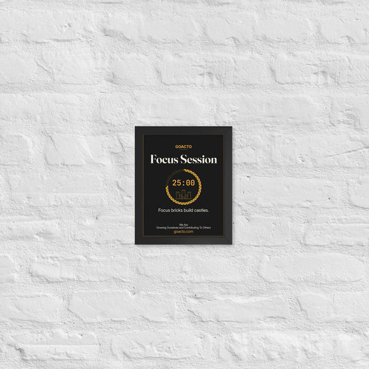 Focus Session Framed Print, Castle Ring design, 8x10 in a black frame on a white brick wall: ring of amber bricks around a 25:00 timer with a small line-drawn castle inside, on charcoal, the line 'Focus bricks build castles.' and 'We Are / Growing Ourselves and Contributing To Others' above goacto.com
