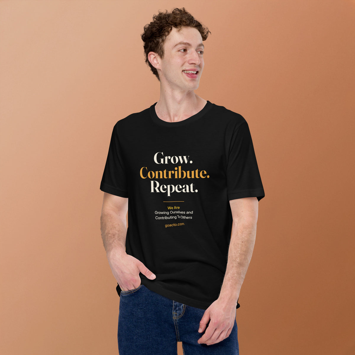 Grow. Contribute. Repeat. Tee, black, worn by a model against a warm tan background, showing the stacked print and mission line on the chest