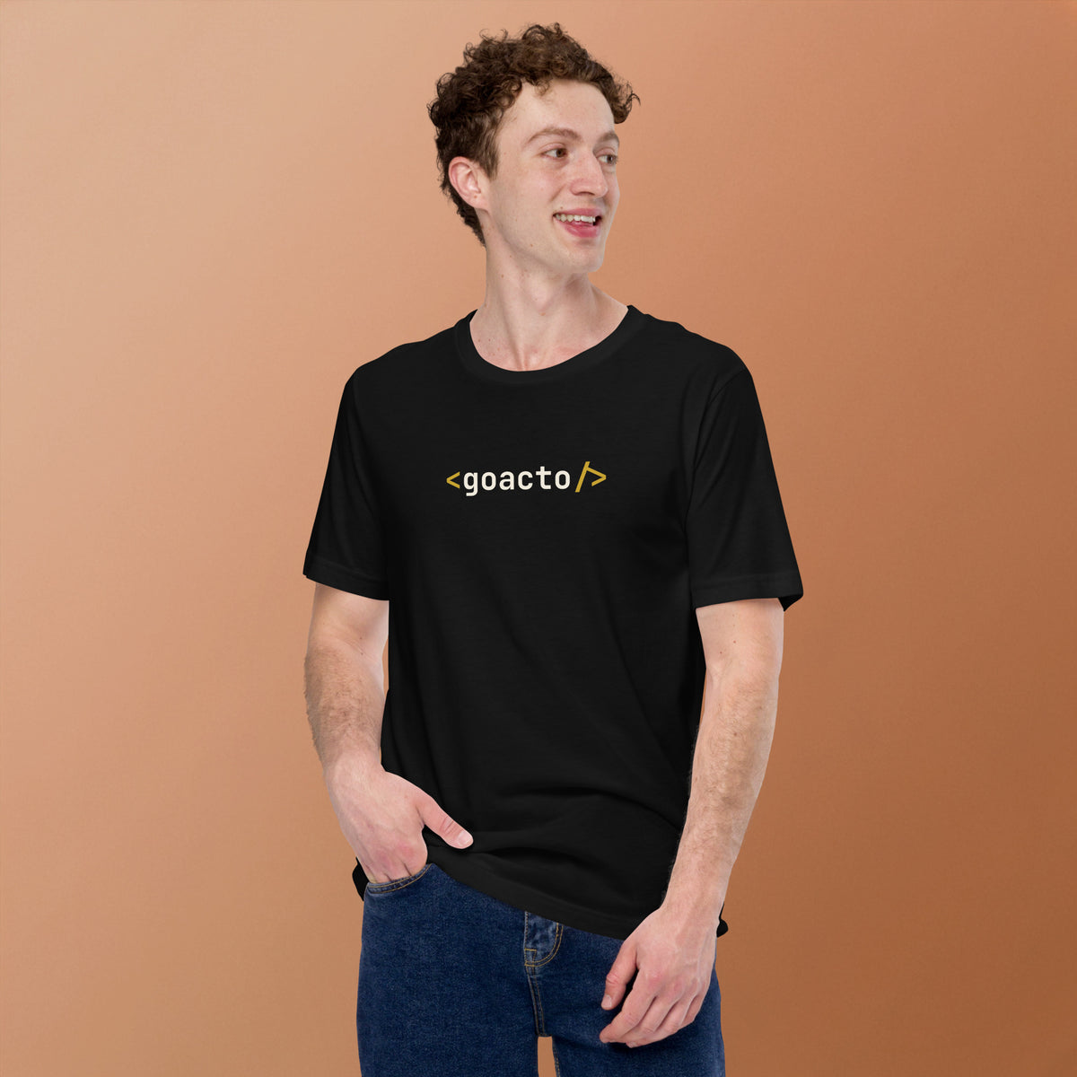 <goacto/> Tee, black, worn by a model against a warm tan background, showing the <goacto/> chest print