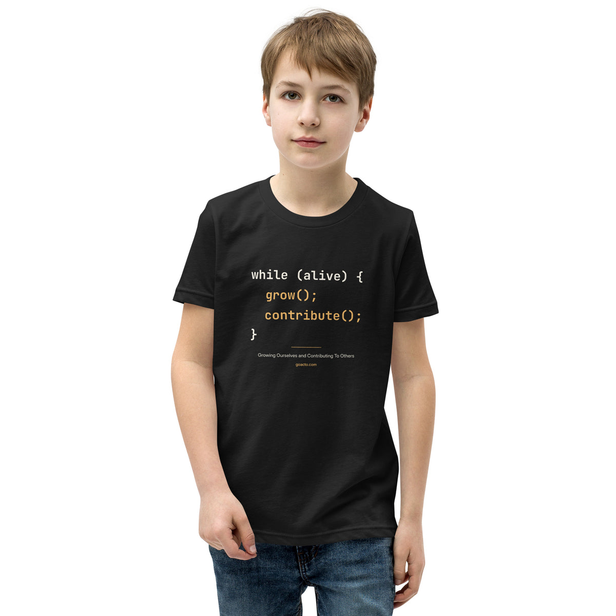 Code Youth Tee, black, front view, with the code "while (alive) { grow(); contribute(); }" printed on the chest in cream and amber monospace type, above "Growing Ourselves and Contributing To Others" and goacto.com